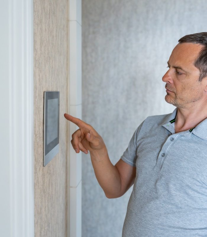Man using tablet panel application for control smart home living. Wireless device controller for