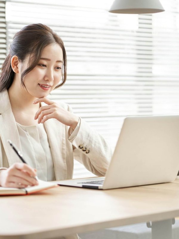 Asian woman taking notes in a coworking space