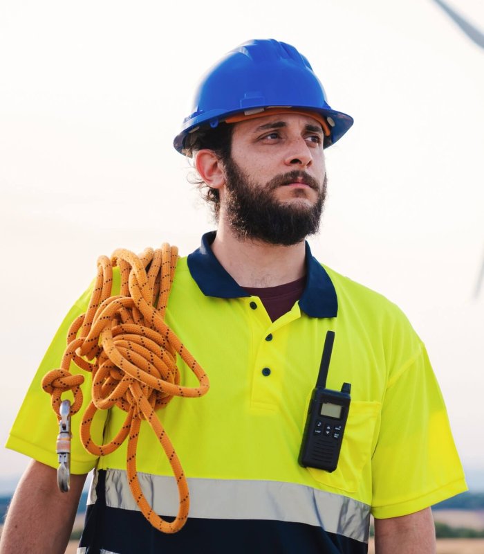 Vertical. Bearded technician engineer of windmill and renewable energy industry working and looking