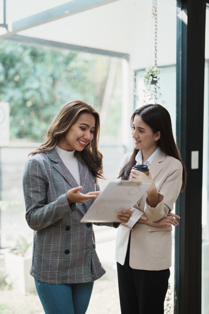 Financial analysts analyzing business reports on planned investment projects during corporate meetin