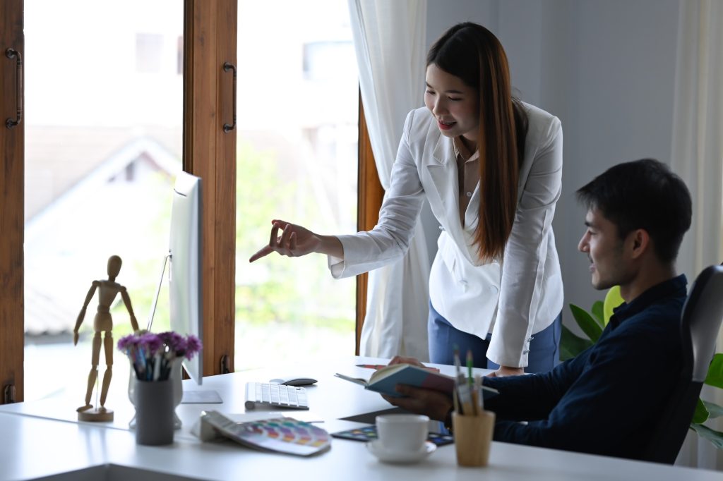 Investment advisor businesswoman and young businessman analyzing financial data.