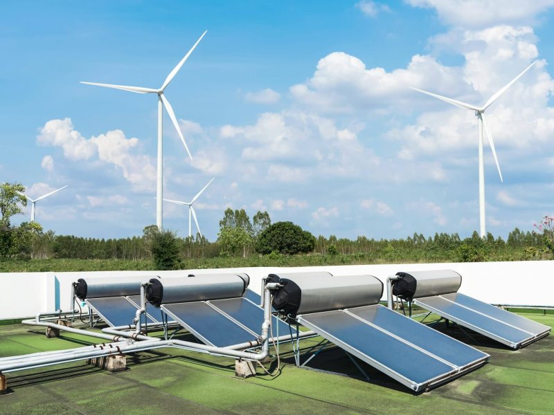 Solar cell energy panels and wind turbines with blue sky. Green energy.