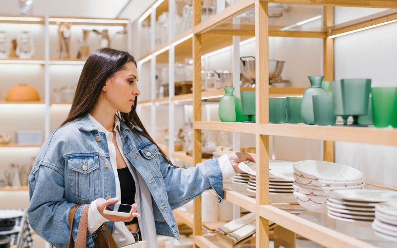 Young Woman Chooses Crockery in a Home Improvement Shop