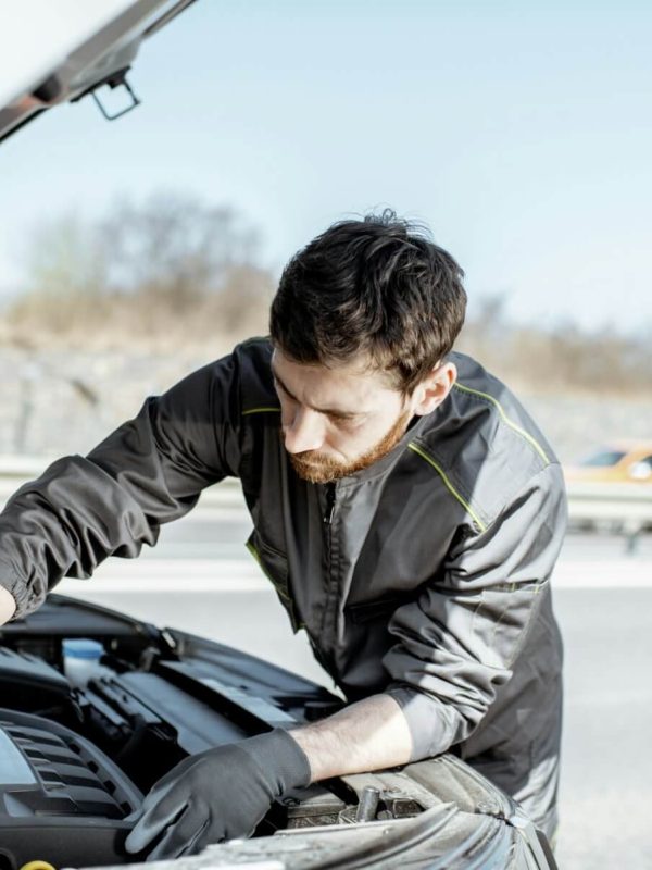 auto-mechanic-repairing-car-outdoors