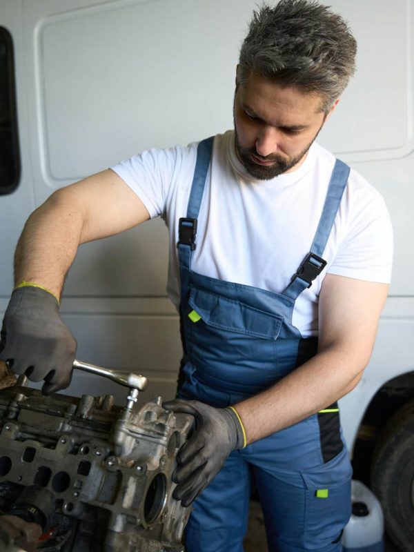 experienced-automotive-technician-fixing-car-engine-in-repair-shop