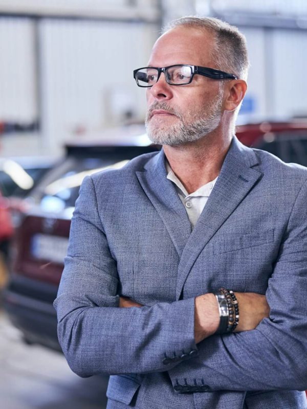 good-looking-bearded-man-standing-in-auto-repair-shop
