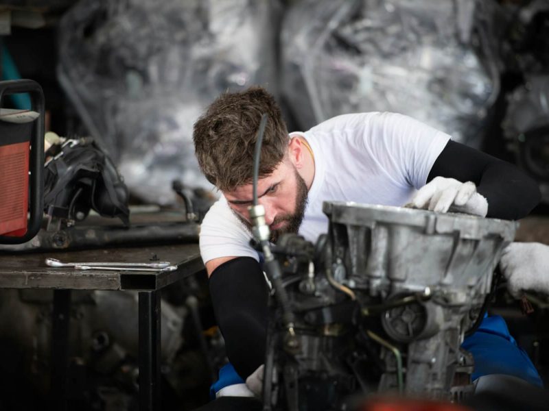men-repairing-car-engine-in-auto-repair-shop-selective-focus-