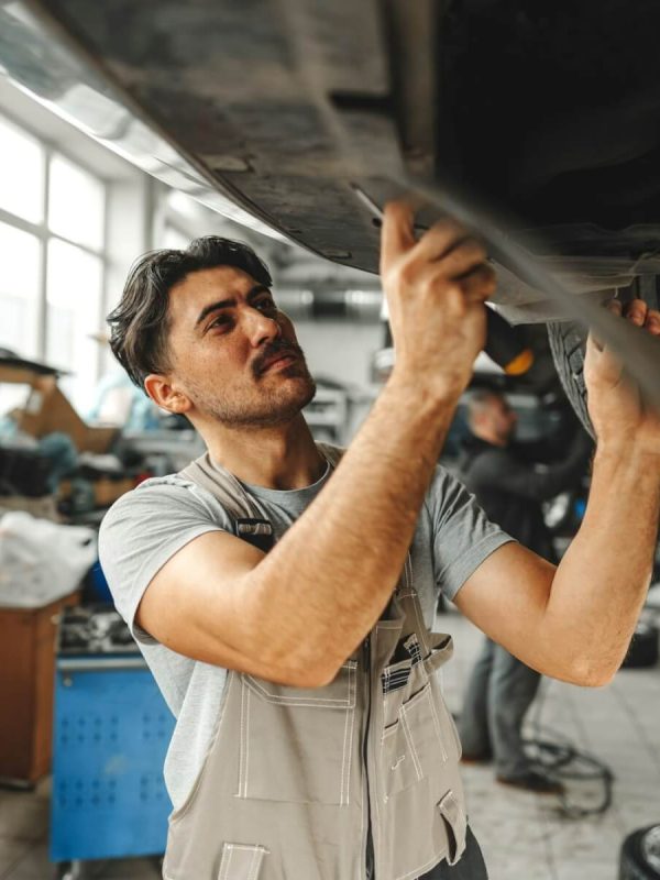 workman-mechanic-working-under-car-in-auto-repair-shop