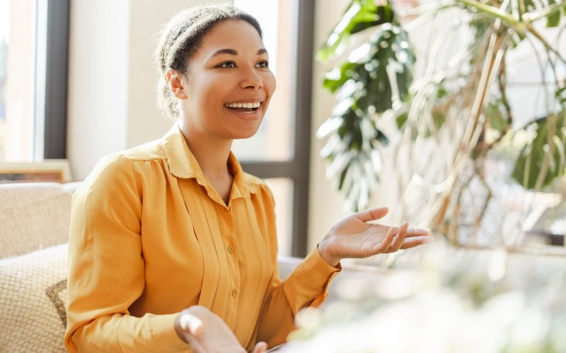 Smiling african american woman learning and communicating in sign language