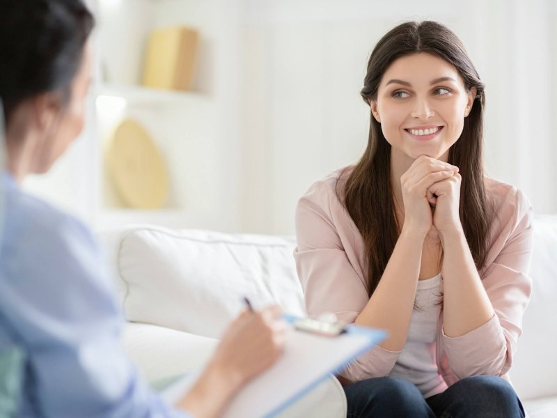 Smiling woman talking to wellness coach about motivation