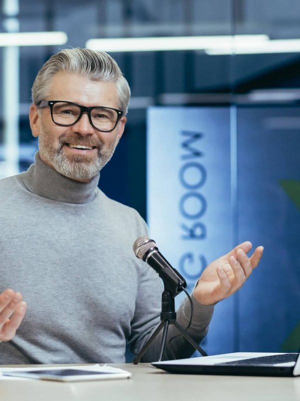 Successful mature financier business coach teacher working inside office with laptop and