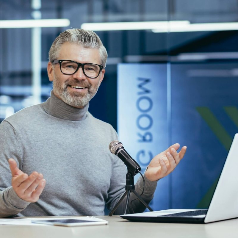 Successful mature financier business coach teacher working inside office with laptop and