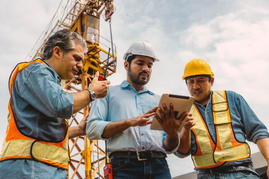 Workers team working together with contractor at construction site. Engineer project teamwork