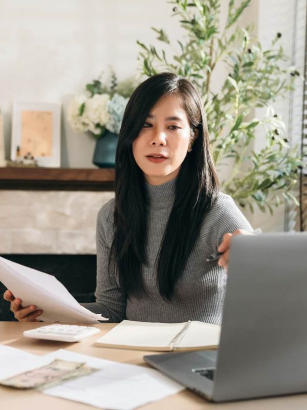 close-up-hand-of-business-woman-using-laptop-while-plan-and-discussion-information-for-financial-