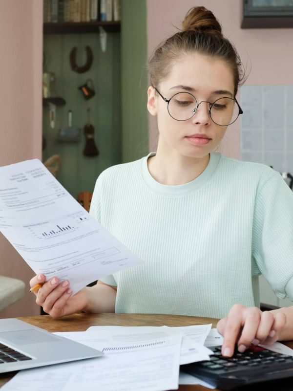 young-beautiful-woman-budgeting-managing-utilities-expenses-writing-financial-plan