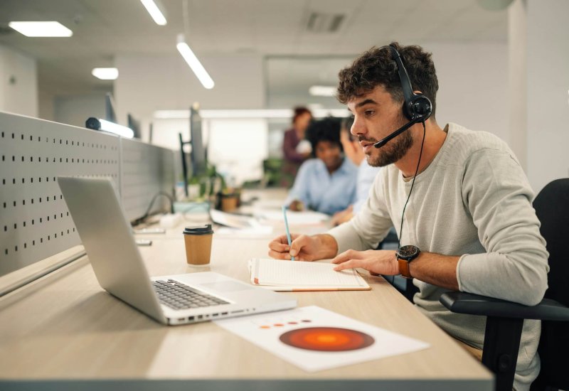 A virtual assistant is sitting at call center department and working.